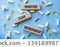Maintain Clean Environment symbol. Concept words Maintain Clean Environment on wooden blocks. Beautiful blue background with pills. Healthcare and Maintain Clean Environment concept. Copy space. 139189987