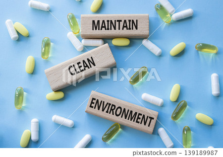 Maintain Clean Environment symbol. Concept words Maintain Clean Environment on wooden blocks. Beautiful blue background with pills. Healthcare and Maintain Clean Environment concept. Copy space. 139189987
