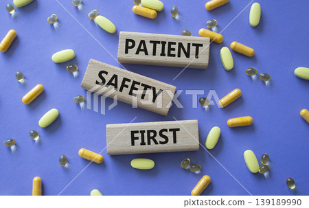Patient safety first symbol. Concept words Patient safety first on wooden blocks. Beautiful purple background with pills. Healthcare and Patient safety first concept. Copy space. Patient safety first symbol. Concept words Patient safety first on wooden blocks. Beautiful purple background with pills. Healthcare and Patient safety first concept. Copy space. 139189990