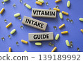Vitamin intake guide symbol. Concept words Vitamin intake guide on wooden blocks. Beautiful purple background with pills. Healthcare and Vitamin intake guide concept. Copy space. 139189992