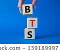 BTS symbol. Wooden cubes with word BTS. Businessman hand Beautiful blue background. BTS concept. Copy space. 139189997