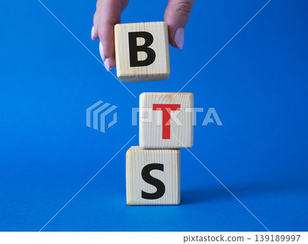 BTS symbol. Wooden cubes with word BTS. Businessman hand Beautiful blue background. BTS concept. Copy space. 139189997