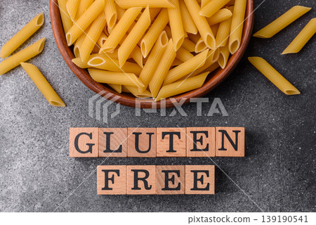 Italian uncooked, dry, gluten free penne pasta, ready for cooking. Dry, gluten free penne pasta 139190541