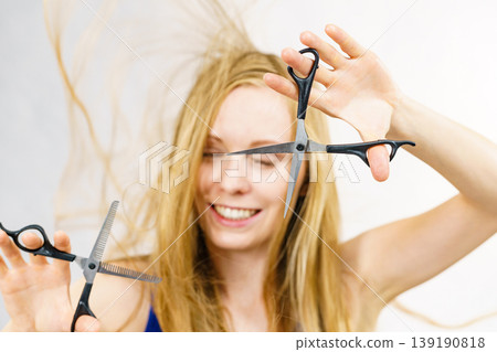 Girl with scissors for haircutting Girl with scissors for haircutting 139190818