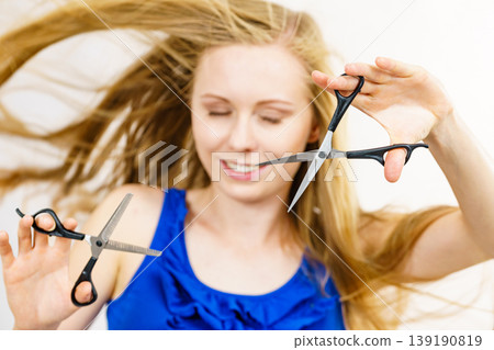 Girl with scissors for haircutting Girl with scissors for haircutting 139190819