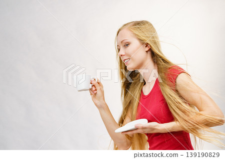 Blonde girl with coffee cup Blonde girl with coffee cup 139190829