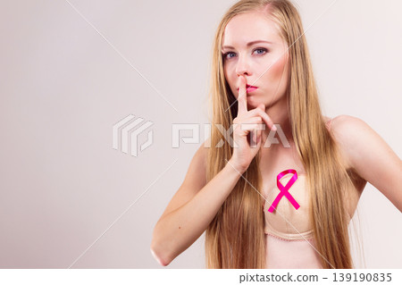 Woman pink cancer ribbon on breast Woman pink cancer ribbon on breast 139190835