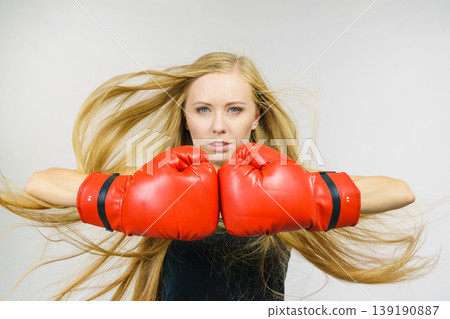 Woman in gloves playing sports boxing Woman in gloves playing sports boxing 139190887