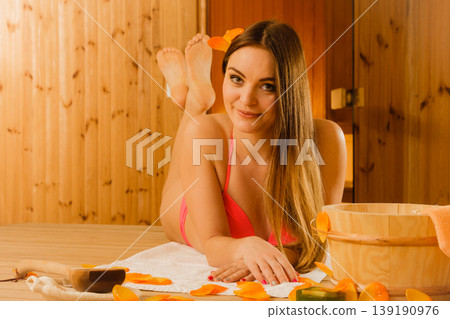 Young woman relaxing in sauna. Spa wellbeing. 139190976