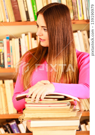 Girl student in college library Girl student in college library 139190979
