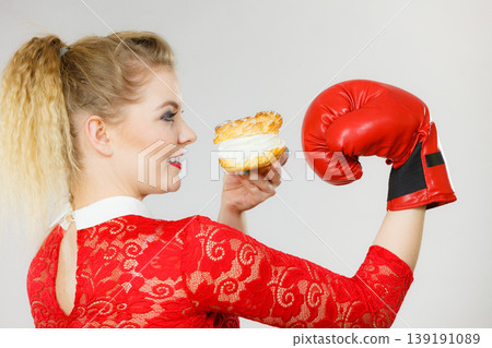 Woman boxing cream cupcake 139191089