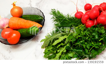 plate with fresh vegetables and a bunch of herbs on a marble table plate with fresh vegetables and a bunch of herbs on a marble table 139191559