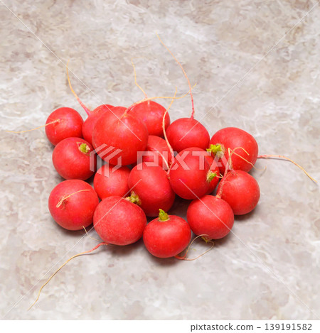 close up of a bunch of ripe red radishes on a marble table 139191582