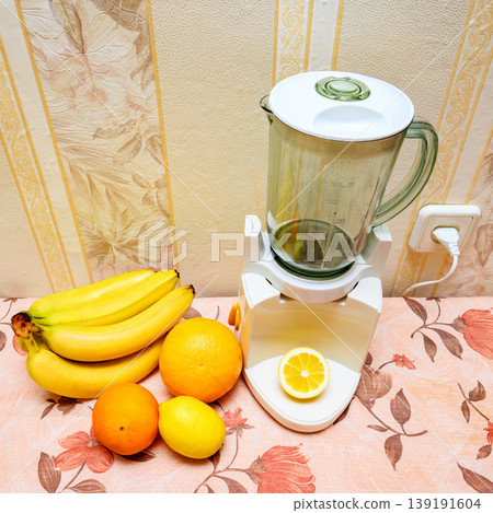 smoothie blender with fresh fruits and a cut lemon 139191604