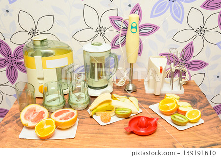 small household appliances set and fruits on the table in the interior 139191610