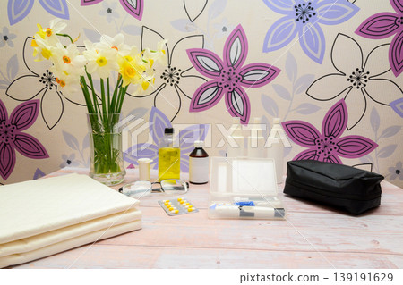 medical still life with flowers pills and glasses in a light interior 139191629