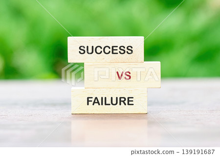 Three wooden blocks stacked vertically on a light surface. The blocks display the words SUCCESS VS FAILURE, symbolizing a critical choice or comparison Three wooden blocks stacked vertically on a light surface. The blocks display the words SUCCESS VS FAILURE, symbolizing a critical choice or comparison 139191687