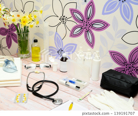 medical set with stethoscope glasses and yellow pills on a table with daffodil flowers medical set with stethoscope glasses and yellow pills on a table with daffodil flowers 139191707