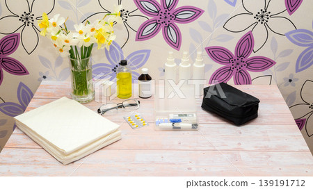 wide shot of medical instruments and a spring bouquet on a wooden table 139191712