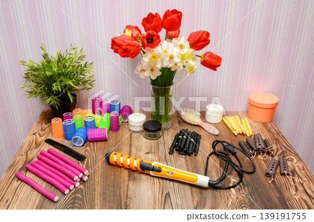large set of hairdressing tools and hair rollers on a table with tulips large set of hairdressing tools and hair rollers on a table with tulips 139191755