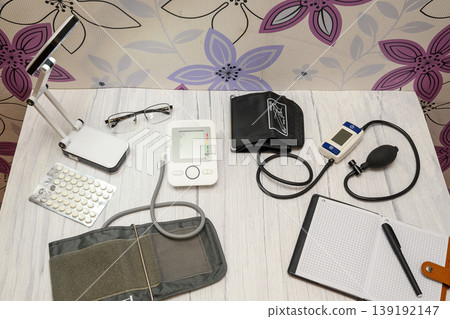 top view of blood pressure monitors and health accessories on a table top view of blood pressure monitors and health accessories on a table 139192147
