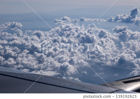ravel by Airplane Window with Sky and Clouds. Airplane Wing View with Blue Sky and Clouds. ravel by Airplane Window with Sky and Clouds. Airplane Wing View with Blue Sky and Clouds. 139192623