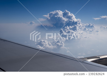 ravel by Airplane Window with Sky and Clouds. Airplane Wing View with Blue Sky and Clouds. ravel by Airplane Window with Sky and Clouds. Airplane Wing View with Blue Sky and Clouds. 139192624