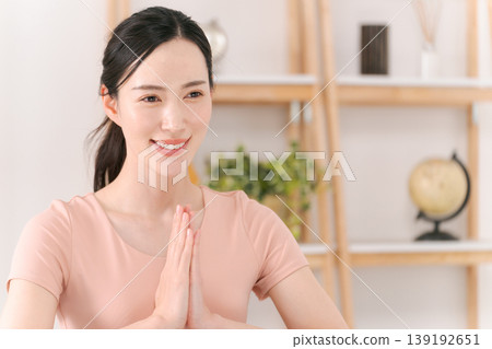 Woman doing yoga in the living room Woman doing yoga in the living room 139192651