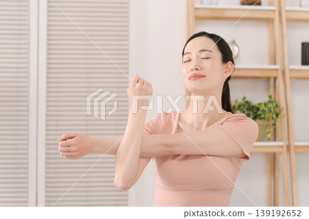 Woman doing yoga in the living room Woman doing yoga in the living room 139192652