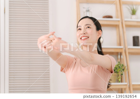Woman doing yoga in the living room Woman doing yoga in the living room 139192654