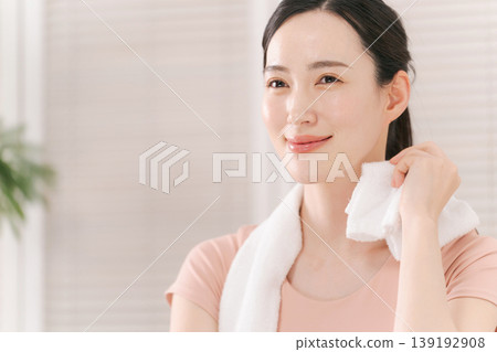 A woman sweating with a towel A woman sweating with a towel 139192908