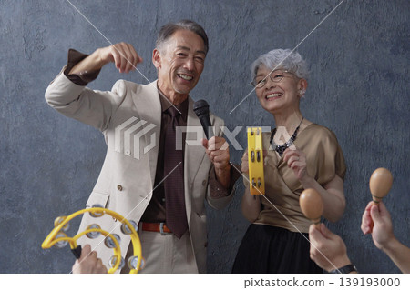 Senior men and women singing karaoke on a black background 139193000