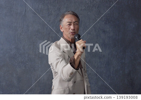 Senior man singing with microphone black background 139193008