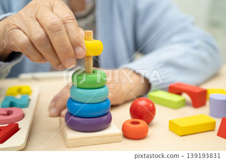 Alzheimer disease AD, Asian elderly woman patient suffering from dementia learn practical motor skills rehabilitation. 139193831