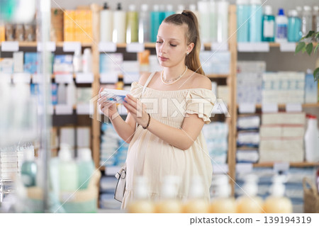Pregnant woman are busy choosing nipple ointment at pharmacy Pregnant woman are busy choosing nipple ointment at pharmacy 139194319