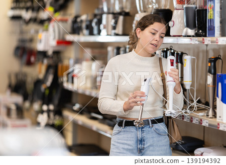 Young woman chooses blender at supermarket 139194392