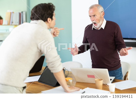 Elderly and young men arguing loudly in office Elderly and young men arguing loudly in office 139194411