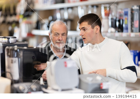 Eldery and young man choosing coffee machine Eldery and young man choosing coffee machine 139194415