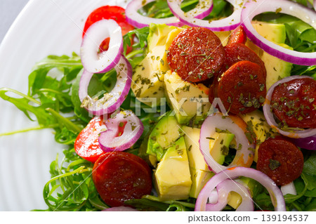 Arugula salad with fried chorizo sausage, avocado Arugula salad with fried chorizo sausage, avocado 139194537