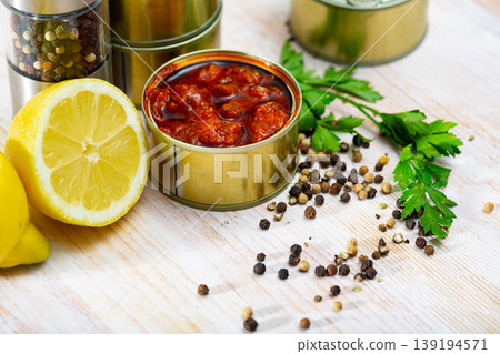 Tasty squids in American Salsa on background with greens and lemon Tasty squids in American Salsa on background with greens and lemon 139194571
