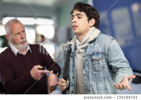 Upset guy employee of company quits job, and mature manager shouts after him. 139194591