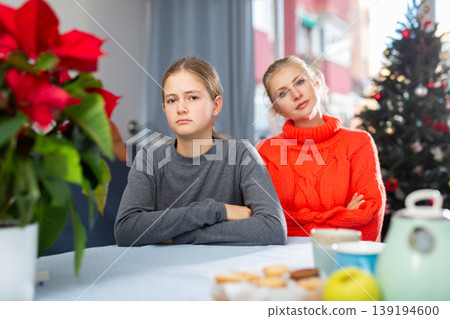 Schoolgirl sitting at the table after quarrel with mother Schoolgirl sitting at the table after quarrel with mother 139194600