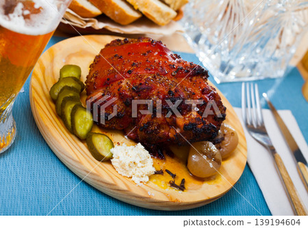 Oven baked pork knuckle with boiled onions and pickled cucumbers Oven baked pork knuckle with boiled onions and pickled cucumbers 139194604