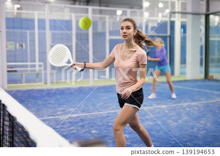 Portrait of a young woman playing padel Portrait of a young woman playing padel 139194653