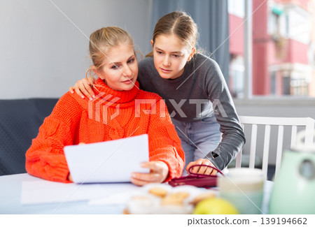 Mother and daughter reading letter Mother and daughter reading letter 139194662