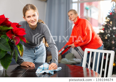 Daughter helps his mother to clean room before christmas Daughter helps his mother to clean room before christmas 139194674