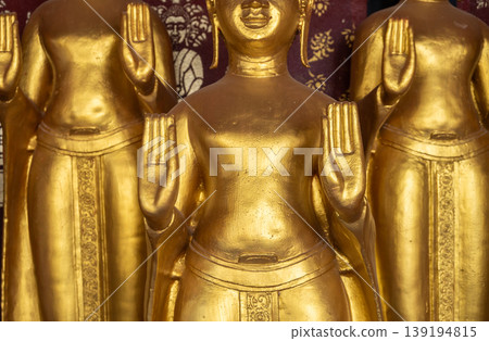 Cropped shot view of golden Buddha statues situated in Wat Sri Donsak, Bokeo province of Laos. Cropped shot view of golden Buddha statues situated in Wat Sri Donsak, Bokeo province of Laos. 139194815