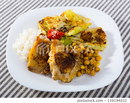 Chicken thighs with cabbage leaves in batter, cheakpea and rice at plate Chicken thighs with cabbage leaves in batter, cheakpea and rice at plate 139194832
