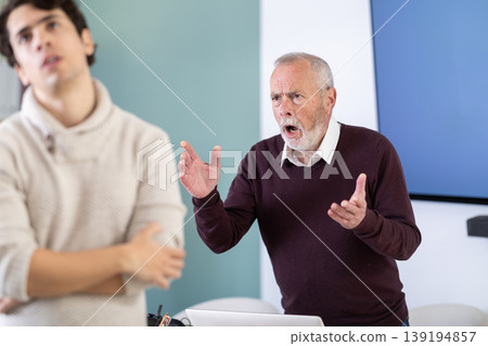 Adult man experiences abuse at work, is criticized by his mature male superiors. Adult man experiences abuse at work, is criticized by his mature male superiors. 139194857