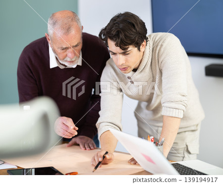 Engineer and architect discussing about blueprint layout design of electricity plan before construction in office 139194917